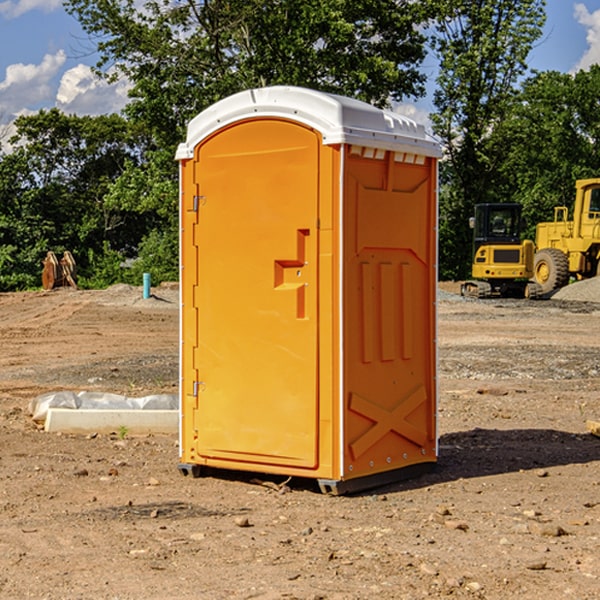 what is the cost difference between standard and deluxe porta potty rentals in Raymond